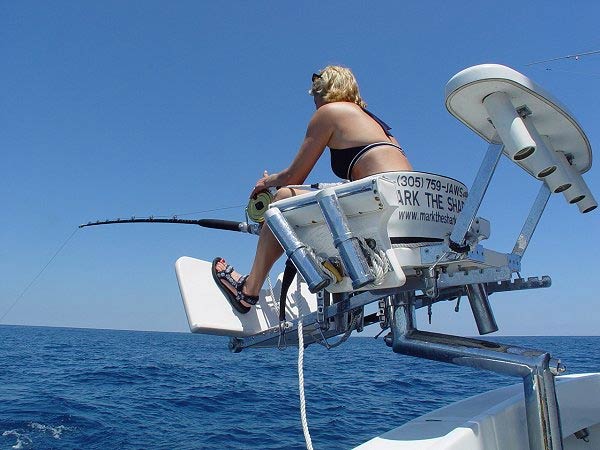 Angler fighting a catch from the chair aboard Mark The Shark