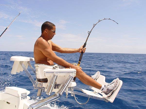 Angler fighting a catch from the chair aboard Mark The Shark