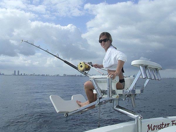 Angler fighting a catch from the chair aboard Mark The Shark