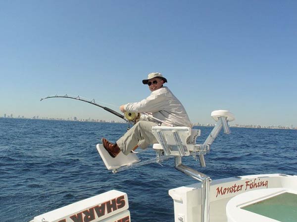 Angler fighting a catch from the chair aboard Mark The Shark