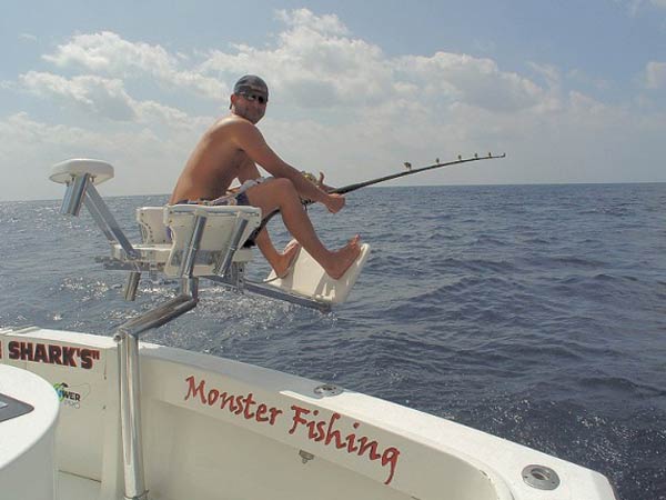 Angler fighting a catch from the chair aboard Mark The Shark