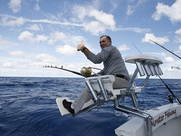Angler fighting a catch from the chair aboard Mark The Shark