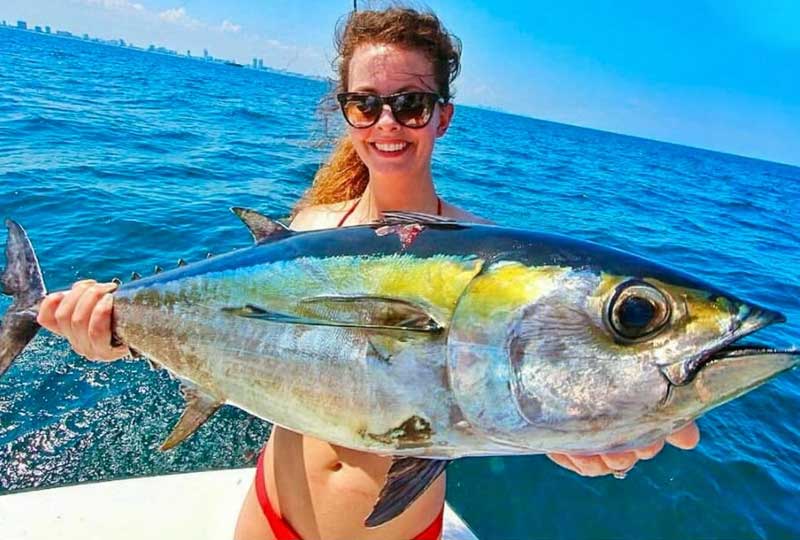 Charter guest holding a big game fish