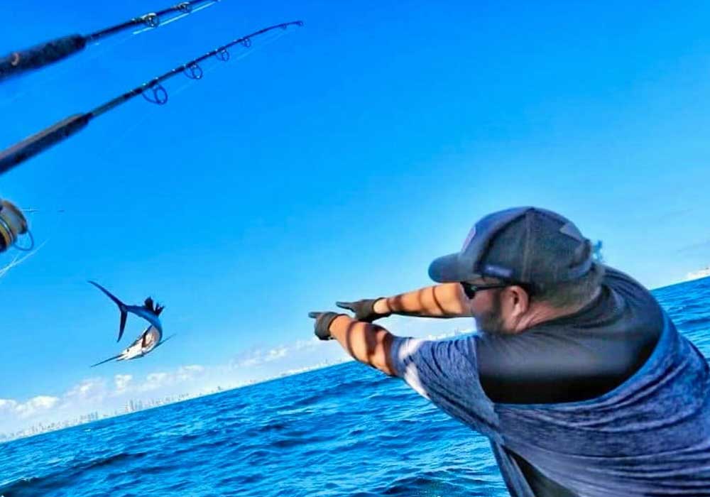 Guests reeling in a big game fish with Mark The Shark